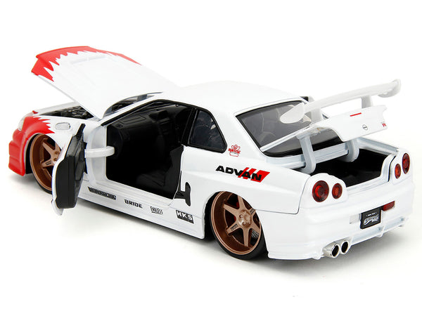 2002 Nissan Skyline GT-R (R34) RHD (Right Hand Drive) White with Red Graphics and Ryu Diecast Figure "Street Fighter" Video Game "Anime Hollywood Rides" Series 1/24 Diecast Model Car by Jada