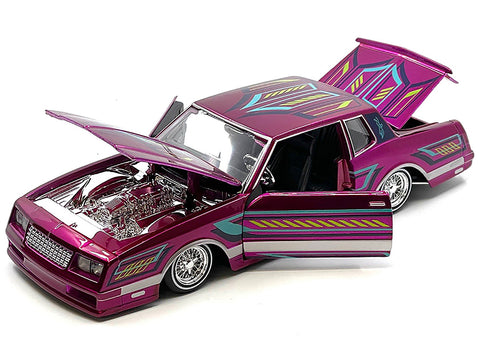 1986 Chevrolet Monte Carlo SS Lowrider Pink Metallic with Graphics "Lowriders" Series 1/24 Diecast Model Car by Maisto