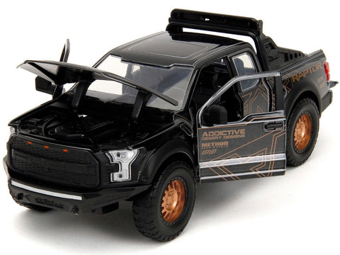 2017 Ford F-150 Raptor Pickup Truck Black with Gold Graphics "Pink Slips" Series 1/24 Diecast Model Car by Jada